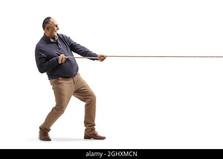 Ganzkörperaufnahme eines reifen Mannes, der ein isoliertes Seil auf weißem Hintergrund zieht Stockfoto