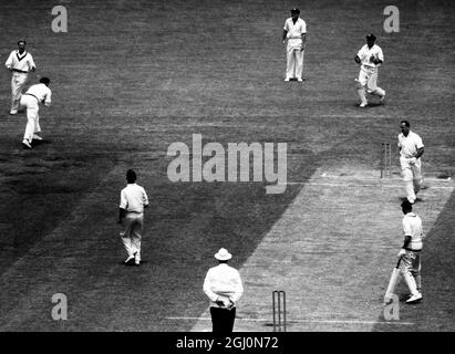 Der englische Cricketspieler Evans (links in der Mitte) wird von Davidson (rechts, gebogen) aus einem Ball von Meckiff (rechts vom Schiedsrichter) für vier Läufe im zweiten Testspiel England gegen Australien in Melbourne gefangen. Januar 1959 Stockfoto