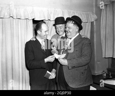 Edward Cross aus Aberdeen flog nach London, um die Rekorddividende von £61 456 für den Fußball-Pool zu sammeln. Mr Cross wurde von Stan Laurel und Oliver Hardy im Palladium Theatre in London überreicht, die sich eine Auszeit von ihrer persönlichen Auftritt-Tour durch Großbritannien genommen haben. 26. März 1947 Stockfoto