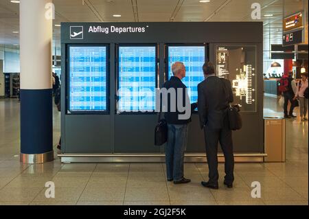 06.06.2016, München, Bayern, Deutschland, Europa - Flugreisende stehen vor dem Flugdisplay mit Abfluginformationen im Passagierbereich. Stockfoto