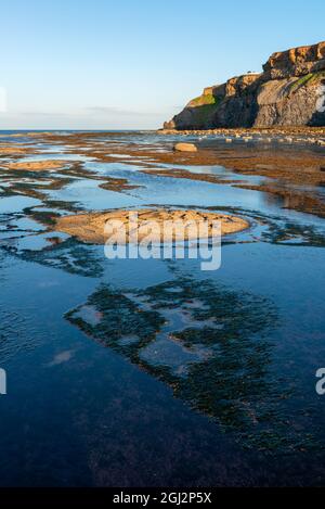 Am späten Abend leuchten die Felsformationen in Saltwick Bay, in der Nähe von Whitby Stockfoto