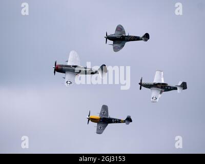 Enger Formationsflug beim Bournemouth Air Festival der Buchon, Supermarine Spitfire, P-47D Thunderbolt 'Nellie' und TF-51D Mustang 'conträren Mary'. Stockfoto