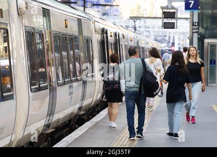 Öffentlicher Nahverkehr Großbritannien - Bahnreisen Großbritannien; Passagiere, die einen Zug auf dem Bahnsteig nehmen, Kings Cross Railway Station, London Großbritannien Stockfoto