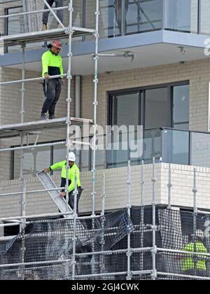 Gosford, NSW, Australien - 15. Juli 2021: Arbeiter bauen Gerüste in den nun fertiggestellten oberen Stockwerken des neuen sozialen Wohnbaus bei 56-58 Bean aus Stockfoto