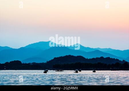 China, Zhejiang, Hangzhou. Sonnenuntergang am West Lake. Stockfoto