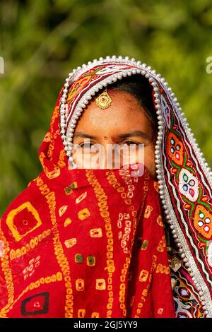 Indien, Gujarat, Bhuj, Great Rann of Kutch, Ahir Tribe. Porträt einer Ahir-Frau in ihrem farbenfrohen roten Kleid. (Nur Für Redaktionelle Zwecke) Stockfoto