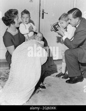 Colin Cowdrey 's drittes Kind eine Tochter Carolyn Susan in Taufroben von Mutter Penny Chiesman gehalten mit Söhnen Jeremy Colin und Christopher Aufnahme der Veranstaltung mit einem Video Dreharbeiten in ihrem Haus in Bickley 1962 Christopher hilft seinem Vater Stockfoto