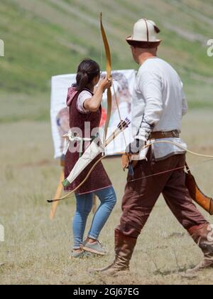 Traditionelles Bogenschießen. Folk- und Sportfestival zum Gedenken an Herrn Koshomkul, einen Sportler und Volksheld des letzten Jahrhunderts in Kirgisistan. (Redaktionelle Verwendung Auf Stockfoto