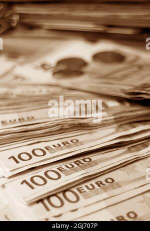 Nahaufnahme Paket von Euro-Banknoten und Münzen in Sepia-Ton Stockfoto