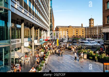 Die Menschen genießen die Bars und Restaurants rund um die St. Katharine Docks, London, Großbritannien. Stockfoto