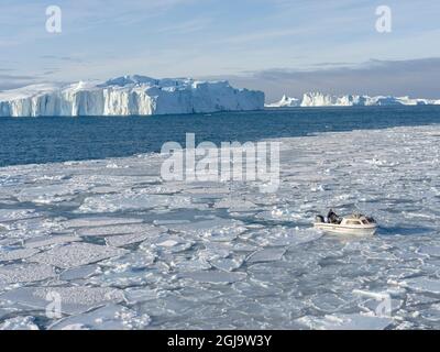 Fischer fischen im Fjord. Winter am Ilulissat Fjord, der in der Disko Bay in Westgrönland liegt, ist der Fjord Teil des UNESCO-Welterbes Stockfoto