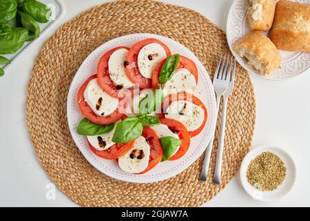 Frischer italienischer Caprese-Salat mit Mozzarella, Tomaten, Basilikum, Olivenöl und Ciabatta Stockfoto