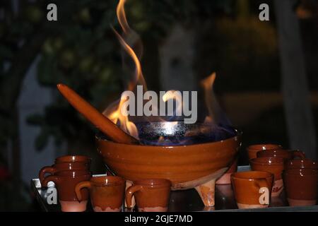 Männliche hand Vorbereitung a Queimada, traditionelle galizische alkoholische Heißgetränk. Stockfoto