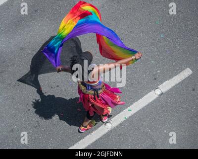 USA, Washington State, Seattle, Frau mit Regenbogenschal tanzt bei der Seattle Pride Parade. (Nur redaktionelle Verwendung) (MR) Stockfoto