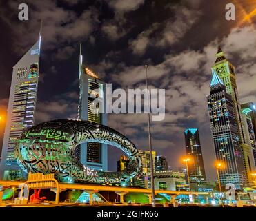 DUBAI, VEREINIGTE ARABISCHE EMIRATE - 27. Feb 2021: Einzigartige Wolkenkratzer bei Nacht in Dubai, Vereinigte Arabische Emirate Stockfoto