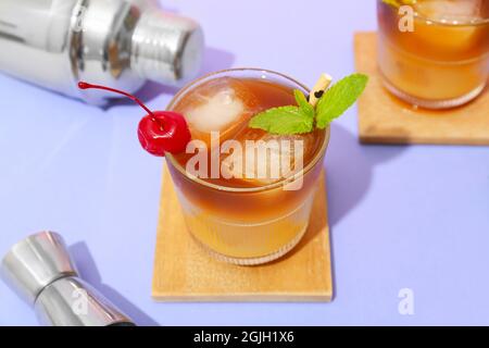 Ein Glas leckeren Mai Tai Cocktail und Shaker auf farbigem Hintergrund Stockfoto