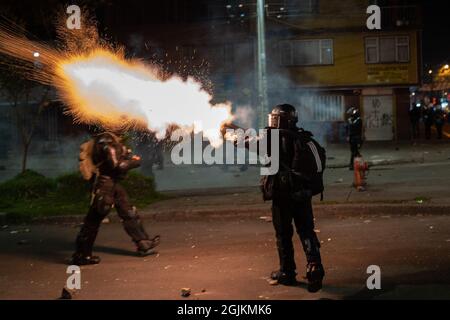 Bogota, Kolumbien. September 2021. Ein Polizeibeamter sah während der Demonstration Tränengas auf eine Menge Demonstranten feuern. Der Streik ist eine Reaktion auf den Jahrestag, an dem die Polizei vor einem Jahr in Bogota, Kolumbien, in einer Nacht 13 Menschen getötet hat. Der Protest ist Teil eines laufenden nationalen Streiks, der am 28. April in Kolumbien als Reaktion auf Steuerreformen begann, die die Ärmsten des Landes zum Ziel hätten. (Foto von David Lombeida/SOPA Images/Sipa USA) Quelle: SIPA USA/Alamy Live News Stockfoto