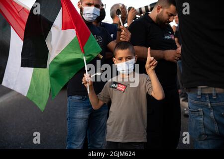 Palästina. September 2021. Arabisch-israelische Demonstranten schwenkten palästinensische Flaggen und Löffel, die diese Woche zur Flucht der sechs palästinensischen Gefangenen aus dem Gilboa Gefängnis verwendet wurden. Der Protest in Umm al-Fahm verurteilte heute die nach dem Gefängnisbruch von den israelischen Gefängnisdiensten ergriffenen Strafmaßnahmen und die Maßnahmen gegen gewalttätige Verhöre. Nach einigen Statistiken wurde einer von fünf Palästinensern zu Lebzeiten in israelischen Gefängnissen inhaftiert. Umm al-Fahm, Israel, am 11. September 2021. (Foto von Matan Golan/Alamy Live News) Quelle: Matan Golan/Alamy Live News Stockfoto