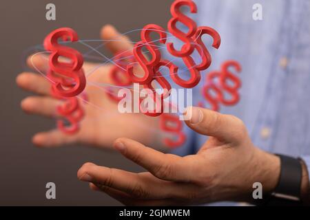 3D-Modellierung von Konzeptfiguren des Roten Rechts und der Gerechtigkeit mit dünnen blauen Drähten über menschlichen Händen Stockfoto
