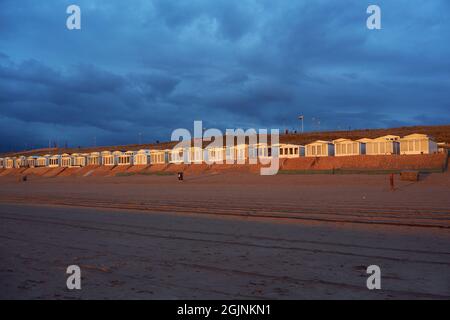 Goldene Strandhütten in Zandvoort in den Niederlanden, beleuchtet vom Sonnenuntergang Stockfoto