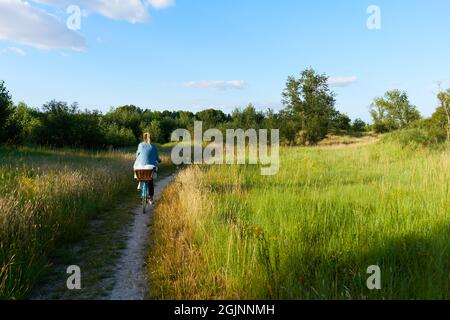 Frau mit Fahrrad von hinten auf dem Weg neben der Loire in Amboise Frankreich Stockfoto