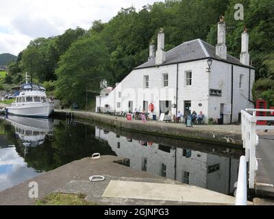 Schottischer Tourismus an der Westküste: Die traditionellen weiß getünchten Gebäude am Eingang zum Crinan-Kanal bieten Reisenden ein Café. Stockfoto