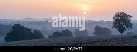 Ein Panoramabild mit Blick auf den Farnely Park und Lower Wharfedale an einem trüben Spätsommermorgen, wobei Almscliffe Crag in der Szene prominent ist. Stockfoto
