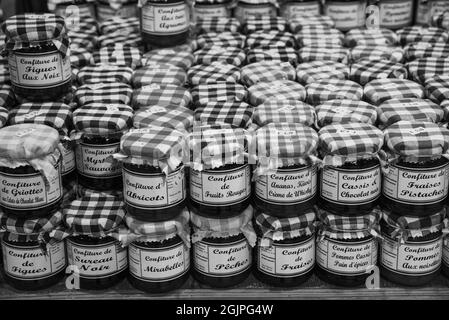 Jura, Frankreich - 1. August 2021: Köstliche handwerkliche Confitures (wie schwarze Johannisbeere mit Schokolade oder Ananas-Whisky) in einem lokalen Lebensmittelgeschäft. Schwarzweißfoto Stockfoto