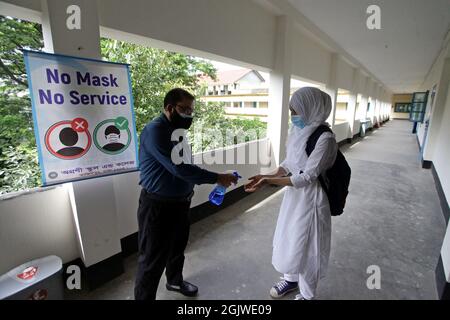 Dhaka, Bangladesch. September 2021. Bangladesch geht mitten in der Pandemie Covid-19 wieder in die Schule. Die Schulbehörden begrüßten die Schüler in den Klassenzimmern, nachdem sie aufgrund der Pandemie von Covid-19 fast eineinhalb Jahre lang geschlossen worden waren. Schüler und Lehrer trugen Masken, benutzten Händedesinfektionsmittel und hielten alle Sicherheitsregeln ein, als sie heute Morgen in die Klassenzimmer gingen. Dhaka, Bangladesch, 12. September 2021. Foto von Habibur Rahman/ABACAPRESS.COM Quelle: Abaca Press/Alamy Live News Stockfoto