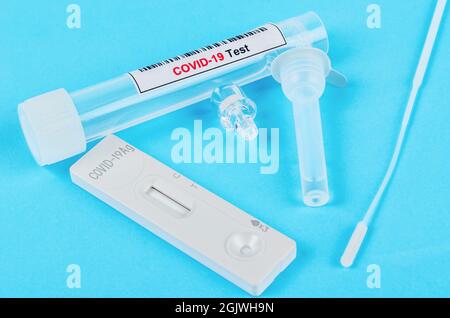 Schnelltests mit Covid-19 AG-Test auf blauem Hintergrund. Stockfoto