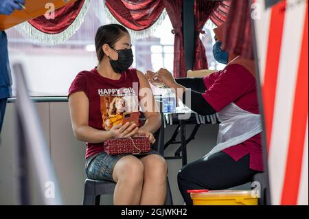 Kuala Lumpur, Malaysia. September 2021. Eine Frau erhält in Klang of Selongor, Malaysia, 12. September 2021, eine Dosis COVID-19-Impfstoff. Malaysia verzeichnete am Sonnabend um Mitternacht einen neuen Höchstwert von 592 eintägigen Todesopfern von COVID-19, was die Gesamtzahl der Todesfälle auf 20,419 brachte, so das Gesundheitsministerium. Quelle: Chong Voon Chung/Xinhua/Alamy Live News Stockfoto
