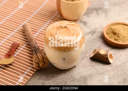 Ein Glas schmackhaften dalgona hojicha und chasen auf hölzernen Hintergrund Stockfoto