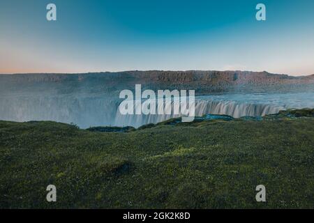 Schöner Hafragilfoss Wasserfall in der Dettiffos Gegend, große Menge Wasser fällt, die einen Tropfenvorhang während des Sommers Sonnenuntergang in satten Farben Stockfoto