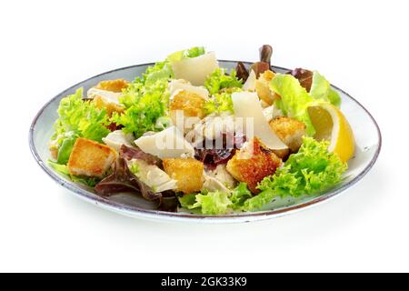 Chicken Caesar Salat, isoliert auf weißem Hintergrund. Romaine-Blätter, knusprige Croutons und Hühnerfiletfleisch Stockfoto