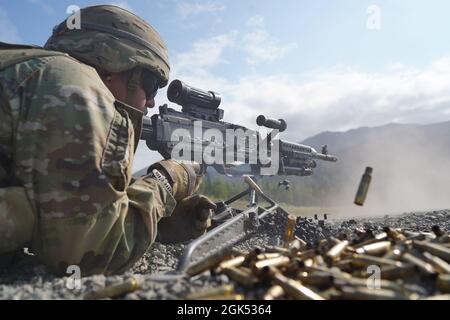 Ein Fallschirmjäger, der dem 6th Brigade Engineer Battalion (Airborne), dem 4th Infantry Brigade Combat Team (Airborne), der 25th Infantry Division, U.S. Army Alaska, zugewiesen wurde, feuert ein M240B-Maschinengewehr, während er ein Live-Feuertraining auf der Statler Range auf der Joint Base Elmendorf-Richardson, Alaska, am 3. August 2021, durchführt. Die Soldaten übten die Identifizierung und das Einbinden von Zielen in unterschiedlichen Entfernungen, um ihre Fähigkeiten mit den Waffen in einer Unterstützung durch Feuerrolle zu festigen. Stockfoto