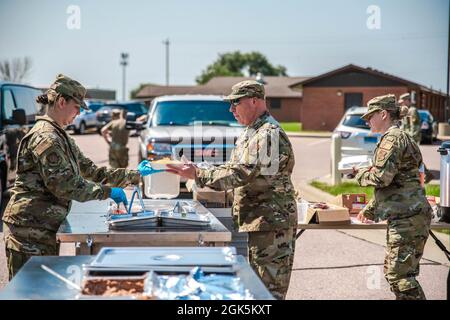 Flieger des 114. Force Support Squadron dienen LT. Col. Kevin Miller, 114. Communications Flight Commander, Mittagessen vom Disaster Relief Mobile Kitchen Trailer (DRMKT) während der Readiness Übung 2021 im Joe Foss Field, South Dakota, 5. August 2021. Das 114. Force Support Squadron nutzte das DRMKT als Teil des Multicapable Airman Trainings während der Bereitschaftsübung. Stockfoto