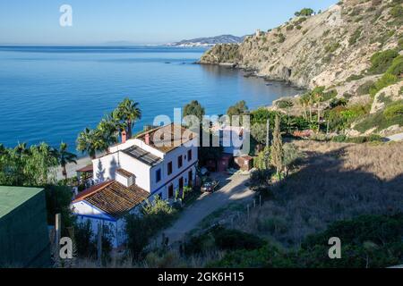 Cañuelo de Nerja Strand von oben mit einem Haus und dem Wachturm im Hintergrund. Maro Cerro Gordo Cliffs Stockfoto