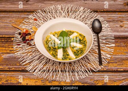 Weiße Schale mit India Palak Paneer auf der Basis von Spinat und gelbem, mit Kuhkäse gerbtem, gelbem Stockfoto