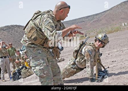 ARTA, Dschibuti (19. August 2021) U.S. Army Sgt. Johnny Peralta der 1. Klasse (links) aus Danbury, Connecticut, 1-102. Infanterie-Regiment (Berg), Task Force Iron Grey, kombinierte Joint Task Force – Horn of Africa (CJTF-HOA), weist einen Soldaten an, wie er aus der Liegestützposition aufstehen und ein Ziel während einer Live-Feuerübung im Dschibuti Range Complex, Dschibuti, 19. August 2021. Die Soldaten sind derzeit im Camp Lemonnier, Dschibuti (CLDJ) stationiert, das als Expeditionsbasis für US-Streitkräfte dient, die Schiffe, Flugzeuge und Personal unterstützen, die die Sicherheit in ganz Dschibuti gewährleisten Stockfoto