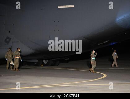 210828-N-OX321-1011 MARINELUFTSTATION SIGONELLA, ITALIEN (AUG 28, 2021) Mitglieder der Flugzeugwartung des 521. Air Mobility Operations Wing arbeiten mit der Boeing C-17 Globemaster III-Besatzung des Schweres-Luftlift-Flügels zusammen, nachdem das Flugzeug mit Evakuierten aus Afghanistan zur Naval Air Station (NAS) Sigonella, 28. August 2021, eintreffen wird. NAS Sigonella unterstützt derzeit die Mission des US-Außenministeriums, um die sichere Ausreise und Umsiedlung von US-Bürgern, Empfängern von Sondereinwanderungsvisa und gefährdeten Bevölkerungsgruppen aus Afghanistan zu erleichtern. Stockfoto