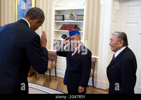 Präsident Barack Obama gibt den Gruß von Tommie Okabayashi, einem der Mitglieder der Gruppe japanischer amerikanischer Veteranen des Zweiten Weltkriegs, während eines Treffens im Oval Office zurück, um ihnen zu ihrer Gold-Medaille im Kongress am 18. Februar 2014 zu gratulieren. (Offizielles Foto des Weißen Hauses von Pete Souza) Dieses offizielle Foto des Weißen Hauses wird nur zur Veröffentlichung durch Nachrichtenorganisationen und/oder zum persönlichen Druck durch die Betreffzeile(en) des Fotos zur Verfügung gestellt. Das Foto darf in keiner Weise manipuliert werden und darf nicht in kommerziellen oder politischen Materialien, Werbung, E-Mails, Produkten, p verwendet werden Stockfoto