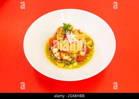 Fisch-Ceviche nach mexikanischem Stil mit Kirschtomaten, roten Zwiebeln, Radieschen und Petersilie Stockfoto