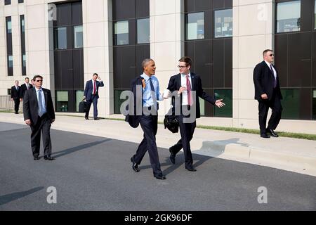 Präsident Barack Obama spricht mit dem Weißen Haus, dem Reiseflieger Bobby Schmuck, während sie zur Landezone des Walter Reed National Military Medical Center gehen, um von Bethesda, MD., 29. Juli 2014 abzureisen. Der Präsident traf sich früher mit 12 verwundeten Kriegern, kranken oder verletzten Dienstmitgliedern und ihren Familien. (Offizielles Foto des Weißen Hauses von Pete Souza) Dieses offizielle Foto des Weißen Hauses wird nur zur Veröffentlichung durch Nachrichtenorganisationen und/oder zum persönlichen Druck durch die Betreffzeile(en) des Fotos zur Verfügung gestellt. Das Foto darf in keiner Weise manipuliert werden und darf nicht in der Kommerse verwendet werden Stockfoto