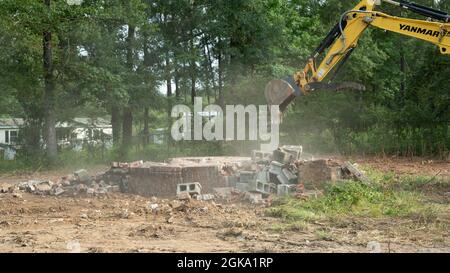Yellow yanmar Bagger Abriss alten Ziegelkamin viel zu löschen Stockfoto