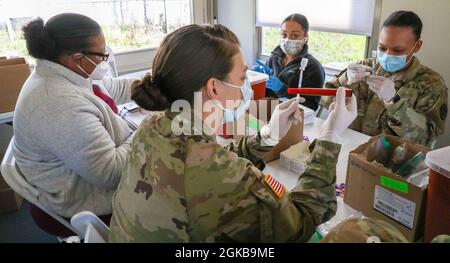 Offiziere der US Army Medical Command arbeiten zusammen mit ehrenamtlichem medizinischem Personal der Federal Emergency Management Agency (FEMA), um am 2. März 2021 in einem COVID-19 Community Impfzentrum in Fair Park, Dallas, COVID-19-Impfungen vorzubereiten. Durch einen bundesstaatlichen Validierungsprozess wurde festgestellt, dass US-Dienstmitglieder die FEMA bei ihren nationalen Bemühungen unterstützen konnten, amerikanische Bürger zu impfen. Das U.S. Northern Command setzt sich über die U.S. Army North weiterhin dafür ein, die Federal Emergency Management Agency als Teil der gesamten Regierung weiterhin flexibel und flexibel zu unterstützen Stockfoto