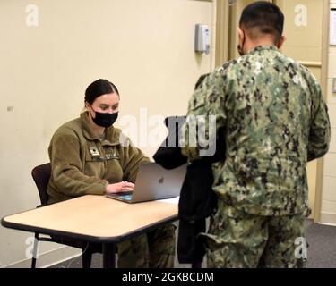 Ein Soldat der Amy National Guard von Michigan, der derzeit beim COVID-19-Impfteam der Nationalgarde von Michigan arbeitet, schließt die Dateneingabe während einer COVID-19-Impfveranstaltung im Fort Custer Training Center, Augusta, Michigan, am 3. März 2021 ab. Die Michigan Army und die Air National Guard kamen vor kurzem zusammen, um eine Impfklinik für Dienstmitglieder und Mitarbeiter des Verteidigungsministeriums im Fort Custer Training Center zu veranstalten. Stockfoto