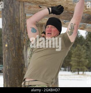 Sgt. Christopher Black von der 860. Militärpolizei schwingt am vierten Tag des Best Warrior Competition 2021 auf dem Camp Navajo, Arizona, über die Affenstangen auf dem Hindernisparcours. Stockfoto