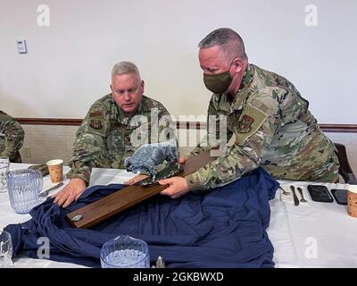 Chief Master Sgt. Scott Peters (rechts), Kommandochef des 914. Lufttankflügels, enthüllt am 7. März 2021 den Professionalisierungspreis mit Col. Carl Magnusson (links), Kommandeur des 914. Lufttankflügels, bei einem Treffen mit Vertretern der 914. Berufsverbände der ARW in der Niagara Falls Air Reserve Station, N.Y. Die Auszeichnung soll jeden Monat an die herausragendsten der sechs Organisationen des Flügels vergeben werden und kann die Münze derer halten, die den Preis verliehen haben. Stockfoto