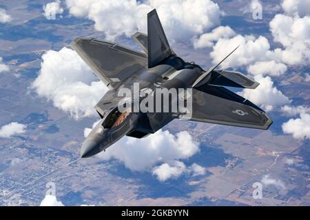 Ein Pilot des F-22 Raptor Demonstrationsteams fliegt hinter einem KC-135 Stratotanker von der 465. Lufttankschwadron, die der Tinker Air Force Base, Oklahoma, im März 8 zugewiesen wurde. 2021. Das F-22-Team von der Joint Base Langley-Eustis, Virginia, wird dem Air Combat Command zugewiesen und erhielt während ihres Rückfluges zu ihrer Heimatstation nach einer Flugshow Treibstoff von den Okies. Stockfoto