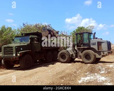 210310-N-WS023-1179 TINIAN, Commonwealth of Nördliche Marianen (10. März 2021) der Ausrüstungsoperator 3rd Class Dillon Bruner, der dem Naval Mobile Construction Bataillon (NMCB) 4 zugewiesen wurde, entfernt überschüssigen Schmutz und Schmutz aus dem Straßenreparaturprojekt von Marpo Heights vor den ersten Phasen des Straßenpflasters. Das Projekt „Innoative Readiness Training Road“ wird nicht verbesserte Straßen nach den Standards des Verkehrsministeriums im Viertel Marpo Heights bringen. NMCB-4 wird im gesamten Indo-Pazifik-Raum und in den Vereinigten Staaten eingesetzt, um größere Kampfeinsätze, Theatersicherheit und Huma zu unterstützen Stockfoto